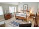 Airy main bedroom featuring large windows and a charming four poster bed at 3619 Loggerhead Ct, Seabrook Island, SC 29455