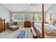 Bright main bedroom with a cozy chaise lounge and large windows with outdoor views at 3619 Loggerhead Ct, Seabrook Island, SC 29455