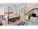 Charming main bedroom featuring a four-poster bed and an adjacent carpeted stairwell at 3619 Loggerhead Ct, Seabrook Island, SC 29455