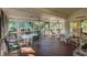 Spacious screened porch with outdoor seating area and multiple ceiling fans at 3619 Loggerhead Ct, Seabrook Island, SC 29455