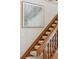 Carpeted wooden stairway featuring a framed nautical map hanging on the wall at 3619 Loggerhead Ct, Seabrook Island, SC 29455