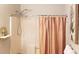 Cozy bathroom featuring a tub with shower and peach colored shower curtain at 40 Bee St # 112, Charleston, SC 29403
