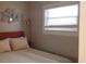 Bright bedroom featuring a comfortable bed, plush pillows, and a sunlit window with white blinds at 40 Bee St # 112, Charleston, SC 29403