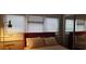 Bright bedroom featuring a comfortable bed, plush pillows, and large windows with blinds at 40 Bee St # 112, Charleston, SC 29403