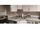 Modern kitchen featuring granite countertops, stainless steel appliances, and sleek white cabinetry at 40 Bee St # 112, Charleston, SC 29403