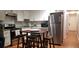 Open kitchen with stainless steel appliances, white cabinets, and a modern kitchen island with stools at 40 Bee St # 112, Charleston, SC 29403