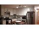 Modern kitchen featuring stainless steel appliances, granite countertops and dark wood table at 40 Bee St # 112, Charleston, SC 29403