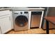 Modern laundry room features a sleek, silver LG washer next to stainless steel dishwasher at 40 Bee St # 112, Charleston, SC 29403