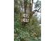 Rustic address sign with clear numbering amidst lush greenery at 415 W Carolina Ave, Summerville, SC 29483