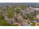 Aerial view of wooded property with homes, a church, and winding driveways at 415 W Carolina Ave, Summerville, SC 29483