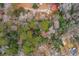 Aerial view of wooded property with homes, a pool, and winding driveways at 415 W Carolina Ave, Summerville, SC 29483