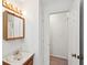 Bathroom vanity with wood cabinet, marble countertop, and decorative lighting at 415 W Carolina Ave, Summerville, SC 29483