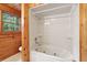 Bathroom with jetted tub and wood paneling at 415 W Carolina Ave, Summerville, SC 29483