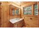 Cozy bathroom featuring vanity, mirror, wood paneling, and lighting at 415 W Carolina Ave, Summerville, SC 29483