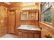Bathroom featuring wood paneling, vanity, and updated fixtures at 415 W Carolina Ave, Summerville, SC 29483