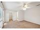 Spacious carpeted bedroom with ceiling fan and connected bathroom and closet at 415 W Carolina Ave, Summerville, SC 29483