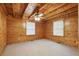 Charming bedroom featuring wood-paneled walls, ceiling fan, and neutral carpet at 415 W Carolina Ave, Summerville, SC 29483