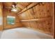 Cozy bedroom with a window, carpeted floor and angled plank walls and a beam ceiling at 415 W Carolina Ave, Summerville, SC 29483