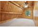 Bedroom with a window, carpeted floor and angled plank walls and a beam ceiling at 415 W Carolina Ave, Summerville, SC 29483