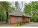 Charming log cabin with a well-manicured lawn, offering a serene and inviting curb appeal at 415 W Carolina Ave, Summerville, SC 29483