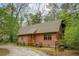 Cozy log cabin with a well-maintained yard surrounded by mature trees at 415 W Carolina Ave, Summerville, SC 29483