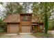 Exterior view of a home with a two-car garage, showcasing its charming curb appeal at 415 W Carolina Ave, Summerville, SC 29483