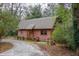 Exterior view of a charming cabin showcasing its rustic design and natural surroundings at 415 W Carolina Ave, Summerville, SC 29483