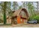 Spacious home featuring two garage doors and a stylish design, accompanied by a parked vehicle at 415 W Carolina Ave, Summerville, SC 29483