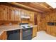 Rustic kitchen with wood cabinets, laminate countertops, and black appliances at 415 W Carolina Ave, Summerville, SC 29483