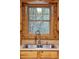 Rustic kitchen wood cabinets, laminate countertops, and stainless sink at 415 W Carolina Ave, Summerville, SC 29483