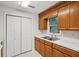 Kitchen features wooden cabinets, stainless steel sink, and white countertops at 415 W Carolina Ave, Summerville, SC 29483