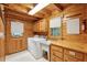 Bright laundry room with white washer and dryer, cabinets, and sink at 415 W Carolina Ave, Summerville, SC 29483