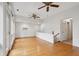 Bright living room features hardwood floors, two ceiling fans, and a wall of large windows at 415 W Carolina Ave, Summerville, SC 29483