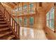 Spacious living room with high ceilings, wood paneling, and a staircase to an upper level at 415 W Carolina Ave, Summerville, SC 29483