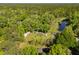 Aerial view of expansive property with mature trees, pond, and several buildings at 4304 River Rd, Johns Island, SC 29455
