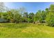 Expansive backyard with mature trees and greenery, offering a serene outdoor space at 4304 River Rd, Johns Island, SC 29455