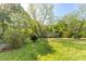 Large backyard with mature trees, lawn, and view of the back of the house at 4304 River Rd, Johns Island, SC 29455