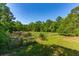 Picturesque land featuring a vibrant green meadow, mature trees and clear blue skies above at 4304 River Rd, Johns Island, SC 29455
