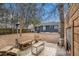Outdoor seating with fireplace in large backyard with trees, with a view of the house at 4530 Holly St, North Charleston, SC 29405