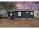 Backyard featuring potential with blue siding and minimal landscaping, under a colorful dusk sky at 4530 Holly St, North Charleston, SC 29405