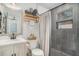 Updated bathroom featuring a modern vanity, decorative shelving, and glass enclosed shower at 4530 Holly St, North Charleston, SC 29405
