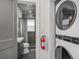 Modern bathroom with a view into the laundry room featuring a fire extinguisher and washer/dryer combo at 4530 Holly St, North Charleston, SC 29405
