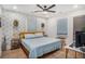 Charming bedroom featuring floral wallpaper accent wall, ceiling fan, king bed, and hardwood floors at 4530 Holly St, North Charleston, SC 29405