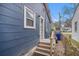 View of the side of the house with a small deck leading up to a side entrance door at 4530 Holly St, North Charleston, SC 29405