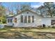 Bright exterior of a home with a yellow door, multiple windows, and inviting curb appeal at 4680 Bears Bluff Rd, Wadmalaw Island, SC 29487