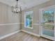 Dining room with modern chandelier and natural light from the window and door at 515 Travelers Blvd, Summerville, SC 29485