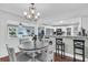 Elegant dining area with hardwood floors, a stylish chandelier, and a convenient breakfast bar at 6017 Ridgecrest Ave, Hanahan, SC 29410