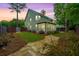 Lovely backyard featuring stone walking path, manicured grass, and a screened-in porch at 616 W 2Nd N St, Summerville, SC 29483