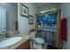 Updated bathroom with granite vanity top, decorative shower curtain and nautical themed artwork at 616 W 2Nd N St, Summerville, SC 29483