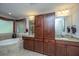 Well lit bathroom featuring a soaking tub, granite countertops, and plenty of storage at 616 W 2Nd N St, Summerville, SC 29483